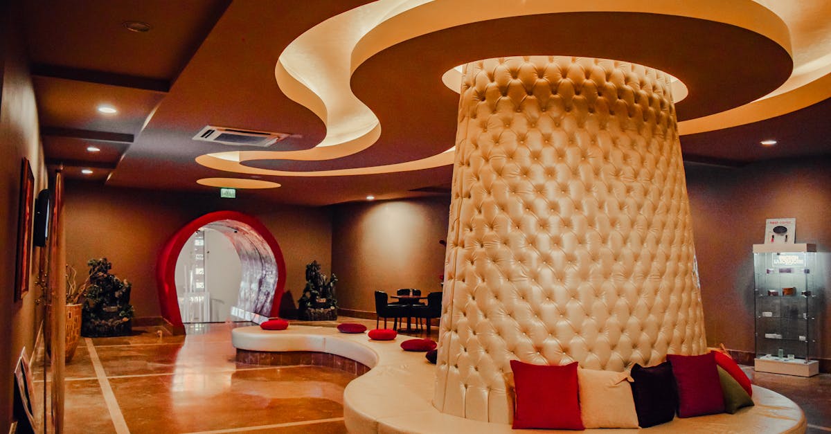 Luxurious indoor setting featuring a modern circular seating area with artistic ceiling design.